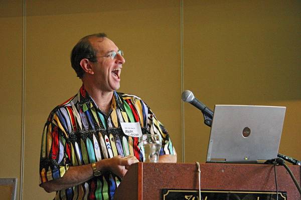 Mark Gibson [demonstrating how to catch flies],  | DSTC Farewell Symposium, 28 July 2005  | 