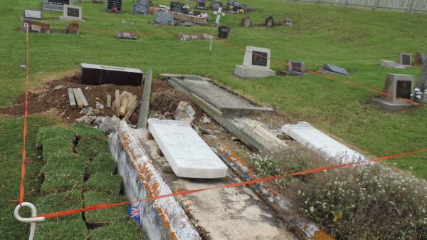 War graves being modified to have grass surround rather than concrete.  | Norfolk Island cemetery  |   | 