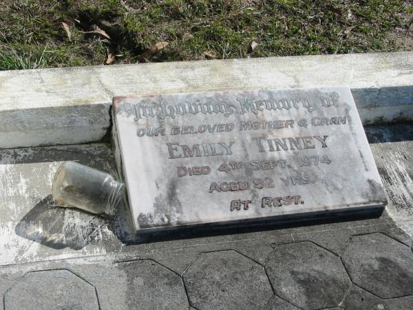 Percy TINNEY, husband father,  | died 18 April 1935 aged 67 years;  | Roy TINNEY, son brother,  | died 3 Jan 1944 aged 34 years;  | Edna Maud, wife of Jack FOX,  | daughter sister,  | died 28 Nov 1959 aged 42 years;  | Emily TINNEY, mother gran,  | died 4 Sept 1974 aged 92 years;  | Woodford Cemetery, Caboolture  | 