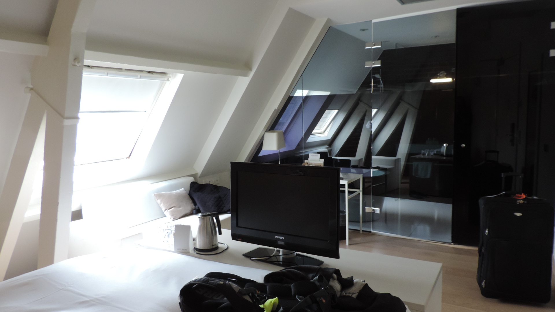 hotel room in loft with glass wall to shower